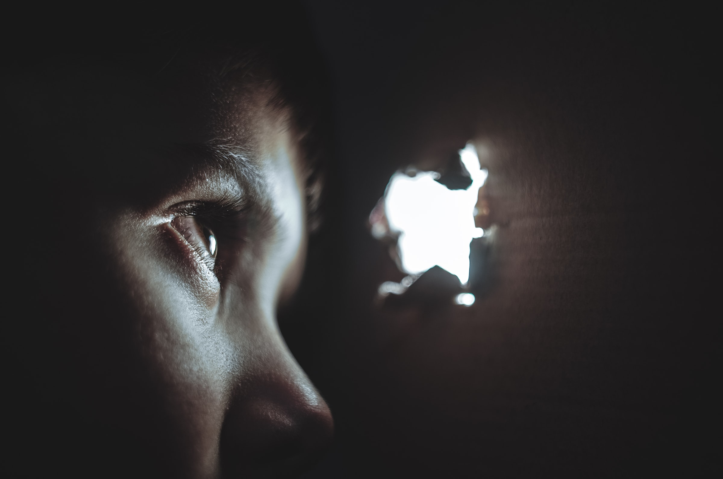 Boy peaking through hole