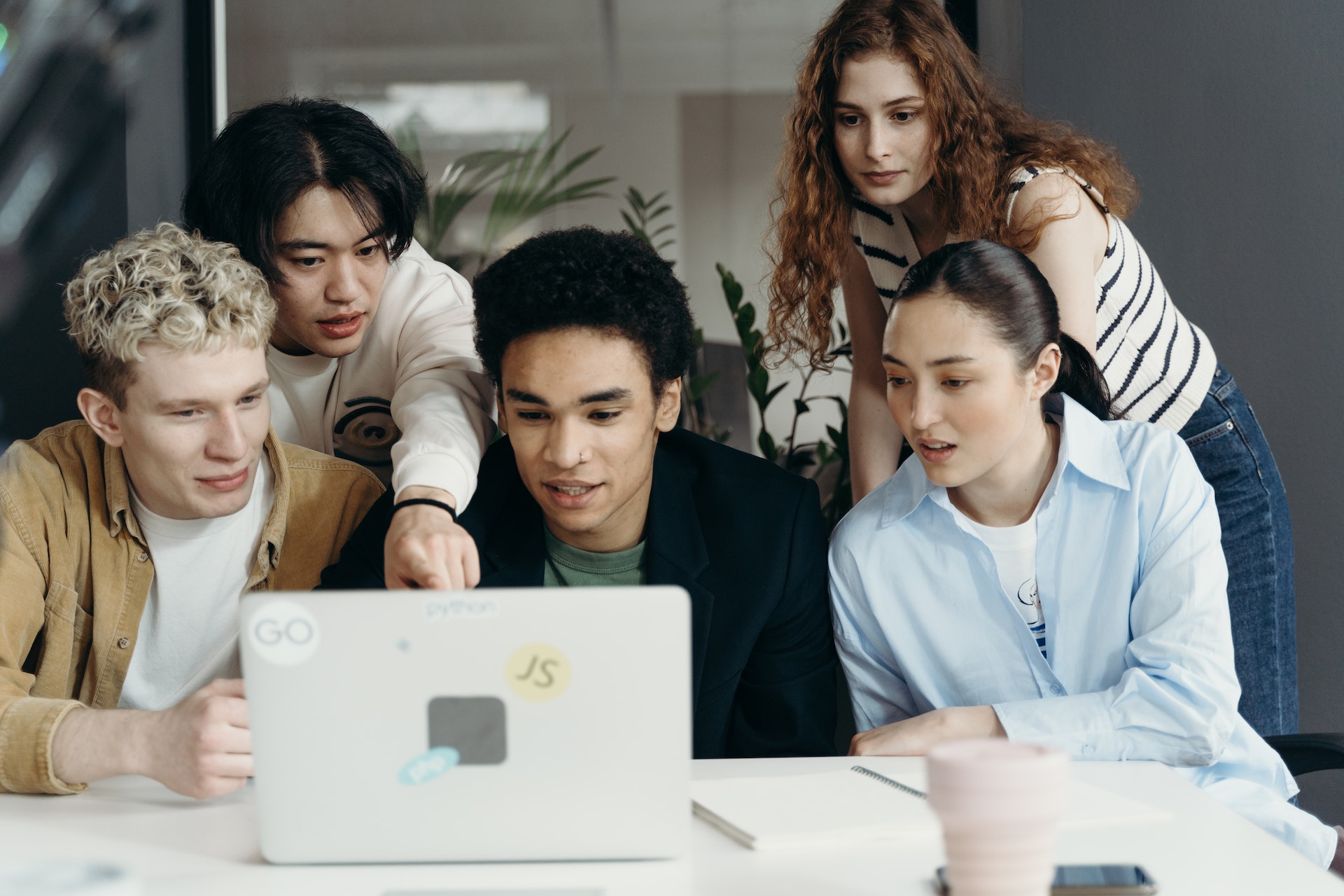 Employees huddled around a laptop