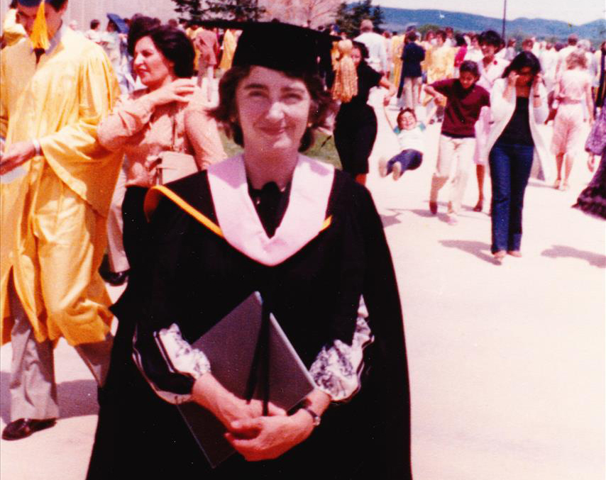 young woman in graduation cap and gown